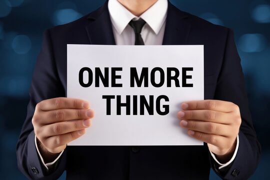 Presenter holding a sign with the phrase One More Thing