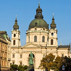 Fototapeta premium Iconic structure with a large dome, spires, and a statue in front. European style architecture. Sunny day