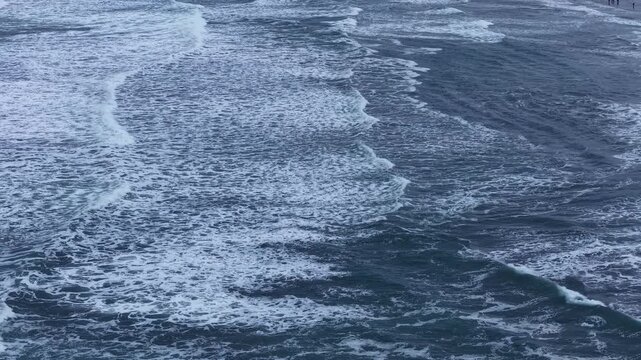 The drone took pictures from top to bottom of the sea surface, which was bumpy with white foam that formed a unique pattern