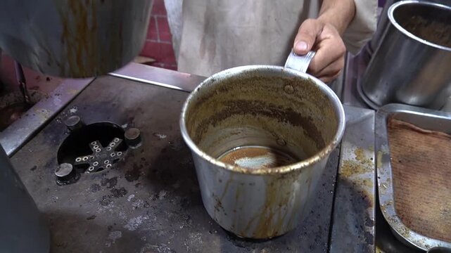 Tea pouring between pots, traditional street-style brewing process, tea culture concept