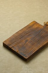 Fototapeta premium Empty rustic wooden chopping board on brown background, made from teak wood. Telenan kayu jati