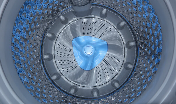 Interior view of an empty washing machine drum featuring a stainless steel texture and a blue plastic impeller at the center