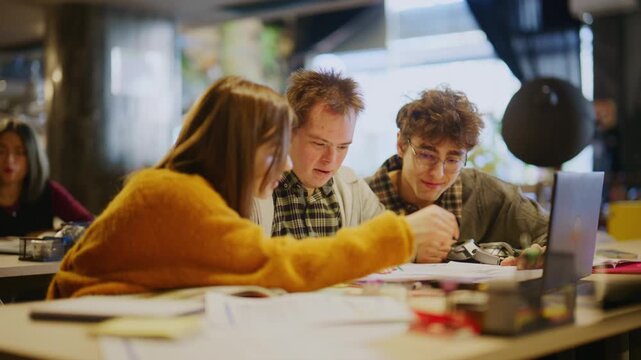 A diverse group of students joyfully collaborates on an academic project. Young learners engage in a supportive group study session.