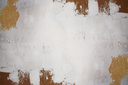 Interior wall with multiple filler spots and plaster marks before painting. Rough texture conveys ongoing renovation and surface refinement.