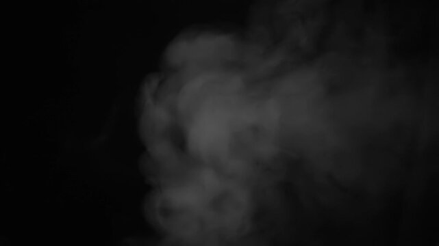 The mysterious and captivating smoke patterns blend seamlessly and beautifully against a dark, enigmatic backdrop