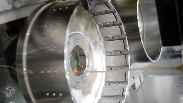 Wire-cut electrical discharge machine. Operation of wire-EDM machine cutting metal parts. Electrical discharge machine EDM cutting metal workpiece. Cutting process by wire cut machine. Vertical