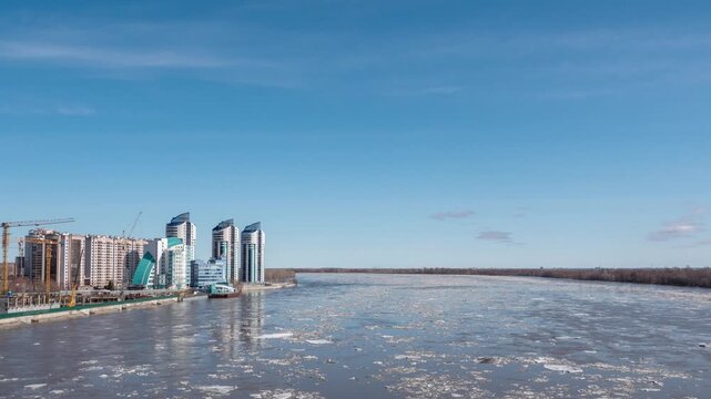 April 09 2026 Barnaul Russia timelapse of ice drift on river floating ice floes blue sky with white clouds spring thaw.