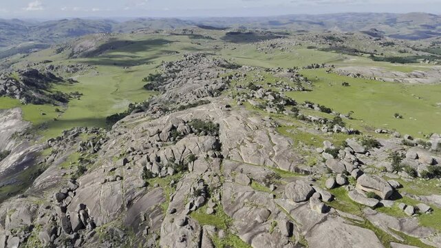 Drone orbits to the left in wide shot of the Sibebe Rock summit near Mbabane, Eswatini on sunny afternoon