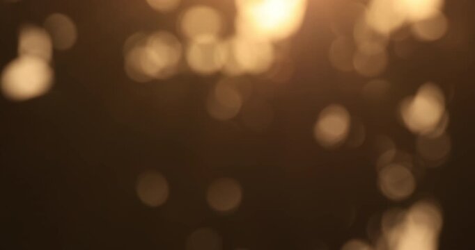 Soft golden bokeh lights out of focus, creating a warm, dreamy atmosphere. Perfect for backgrounds, video overlays, presentations, and motion graphics