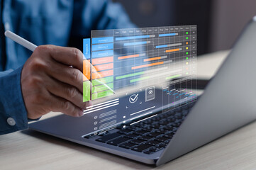 Businessman using digital project management dashboard with Gantt chart on laptop, planning workflow, tracking task, analyzing timeline for productivity, strategy, team collaboration in modern office © PB Studio Photo