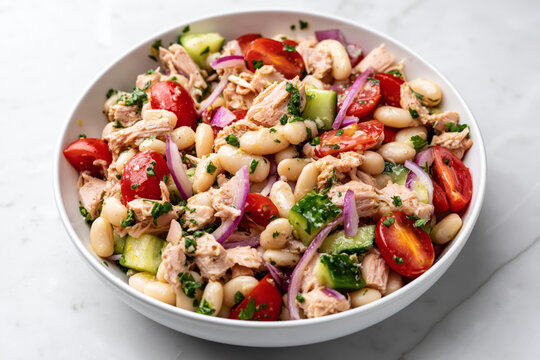 high protein tuna and white bean salad fully mixed in a white ceramic bowl
