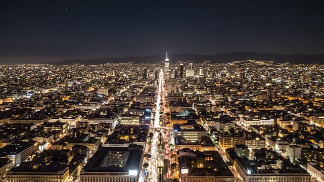 Aerial night cityscape view of a lit metropolis with traffic streaks