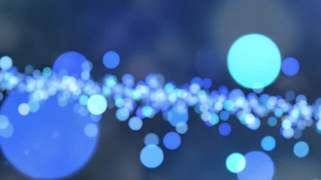 Abstract blue bokeh particles floating against a dark background, dynamic visual for presentations and motion graphics