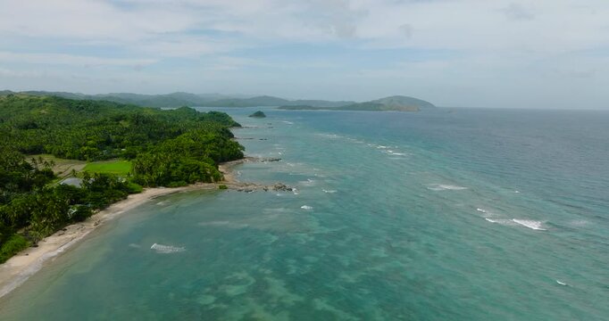 Rocky coastline with turquoise sea water and waves. Santa Fe, Tablas, Romblon, Philippines.