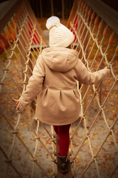 Child on the playground rope maze, entertainment, beautiful child.