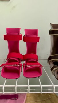 Row of colorful pediatric ankle foot orthosis AFO braces on display