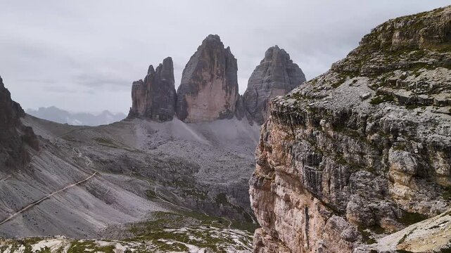 The world-famous Tre Cime di Lavaredo in the Sexten Dolomites are obscured by a rock in this drone shot. The Drei Zinnen are one of the most known mountains in the alps.