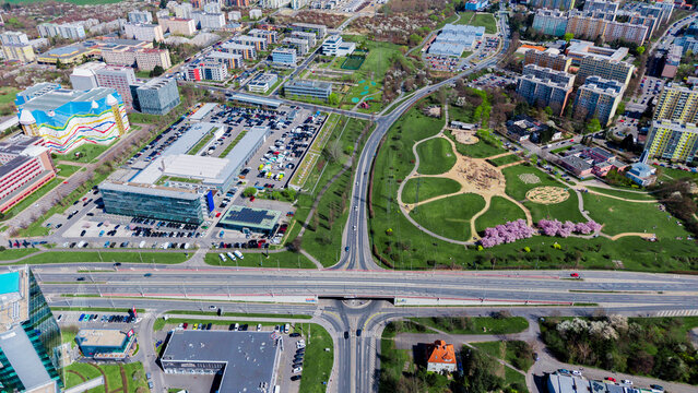 Aerial view of the vibrant cityscape with modern buildings, green spaces, and bustling roadways, capturing the dynamic urban landscape, Prague, Prague, Czechia.