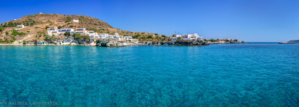 Syrmata boat houses along the goupa rema coast under a bright summer sky in greece
