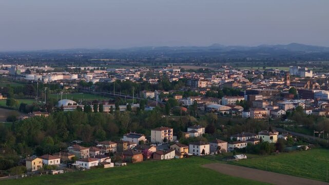 Fiorenzuola d Arda in Piacenza Province Emilia Romagna Italy with town skyline featuring the Collegiata di San Fiorenzo church tower and distant Northern Apennines on the horizon within Po Valley