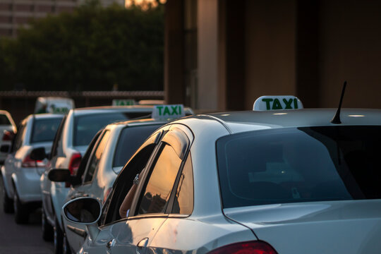 Sao Paulo, Brazil, July 28, 2011.  A row of traditional white taxi cars parked at a designated street stand, waiting for passengers.