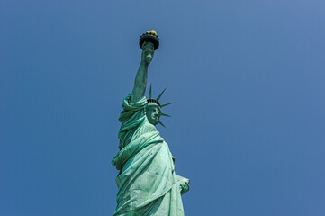 Fototapeta premium Close-up of the Statue of Liberty against Blue Sky 