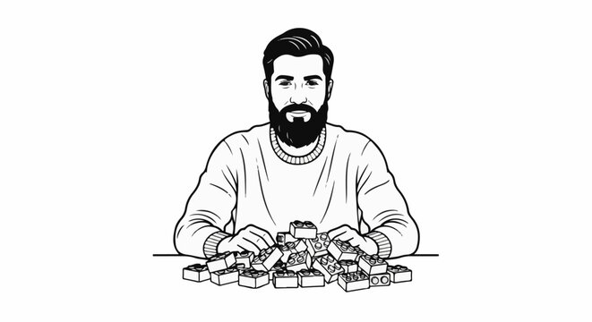 A bearded man in a sweater happily plays with building blocks