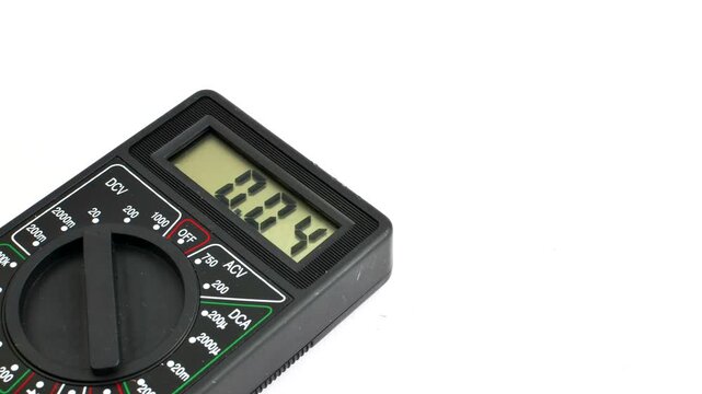 Close-up of a multimeter on a clear surface, highlighting precision and versatility for electrical measurements.