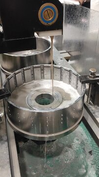 Wire-cut electrical discharge machine. Operation of wire-EDM machine cutting metal parts. Electrical discharge machine EDM cutting metal workpiece. Cutting process by wire cut machine. Vertical