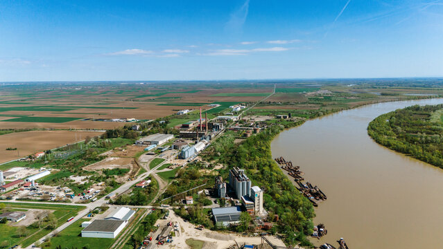 Aerial view of the industrial architecture juxtaposes with the meandering river, a blend of human endeavor and natural beauty, Sremska Mitrovica, Vojvodina, Serbia.