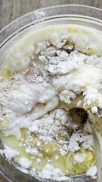 Adding corn kernels to cornbread batter vertical