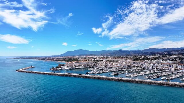 Puerto Ban&uacute;s marina video, aerial drone view of harbor, beach and coastline in Marbella, Spain