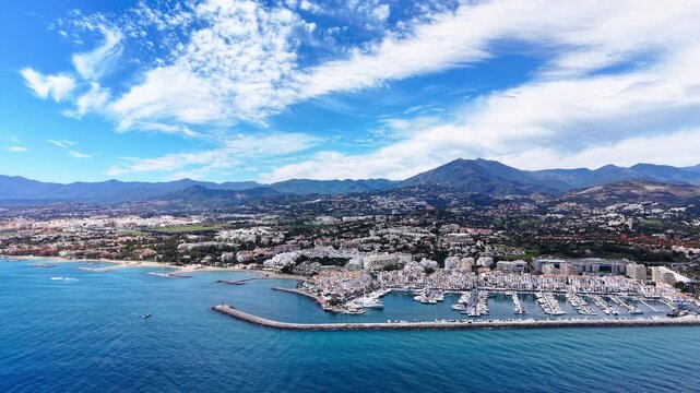 Puerto Ban&uacute;s marina video, aerial drone view of harbor, beach and coastline in Marbella, Spain