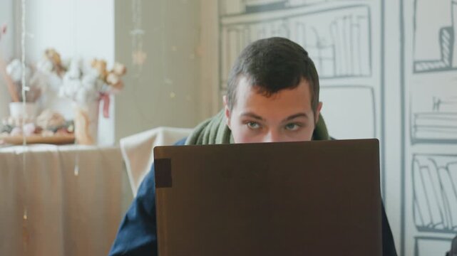 Caucasian man bent over laptop late night coder debugging under warm lamp glow, coffee mug nearby, tense posture and furrowed brow, portraying coder, analyst, student racing deadline