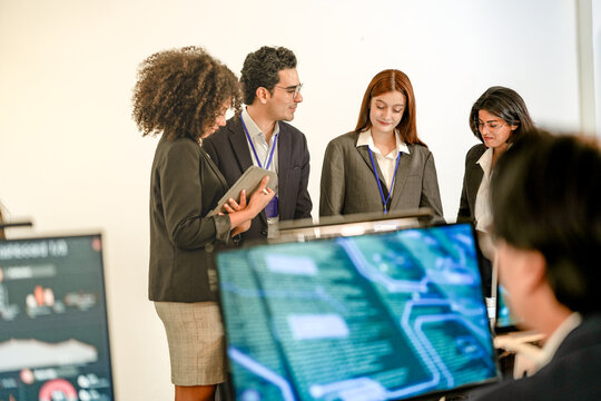 Diverse AI security team planning threat intelligence strategy. Multiethnic DevSecOps experts analyzing machine learning architecture and zero trust protocols in a bright office.