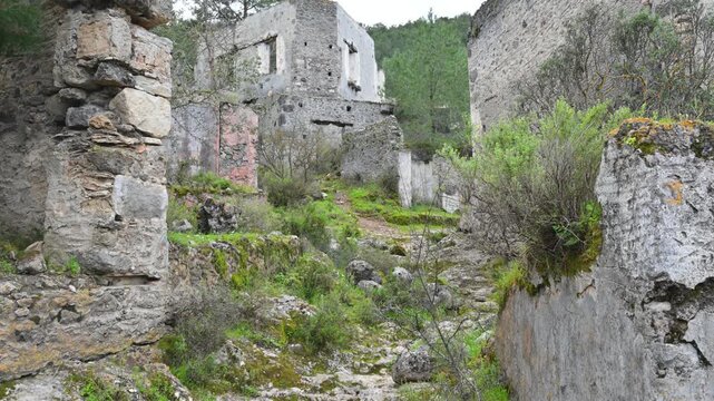 Walking among ancient stone house ruins in Kayakoy, Turkey