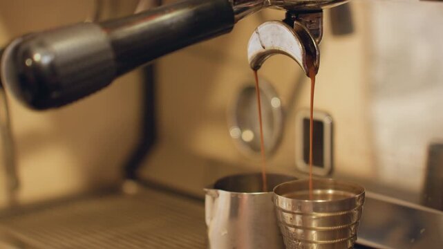 Closeup espresso shot pouring into metal pitcher, warm amber crema streaming from portafilter into measuring cup, textured stainless tray, vintage cafe lighting, slow cozy atmosphere