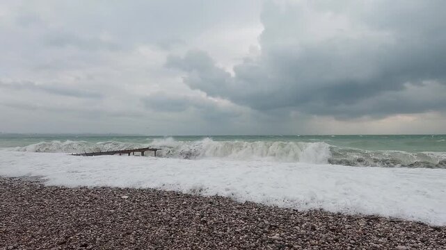 Rough sea waves around old shoreline pier