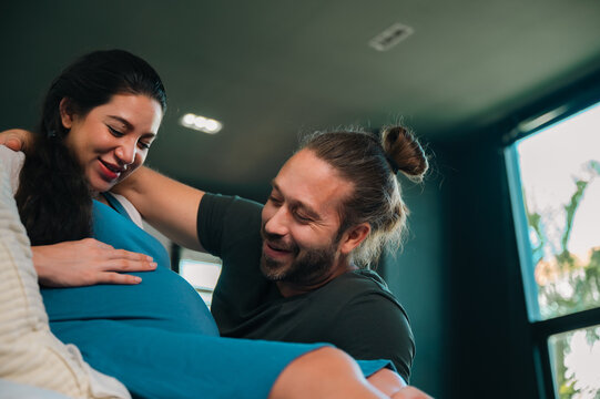 Father's Day Concept, pregnant woman and partner sharing loving moment indoors