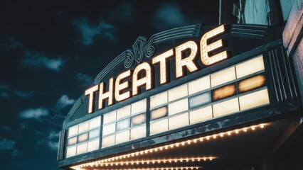 Obraz premium Vintage Theatre Marquee Sign with Bright Neon Lights at Night