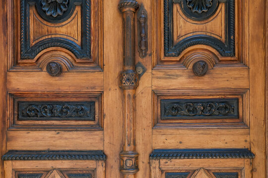 Warm wood door detail with black ornamental inlay