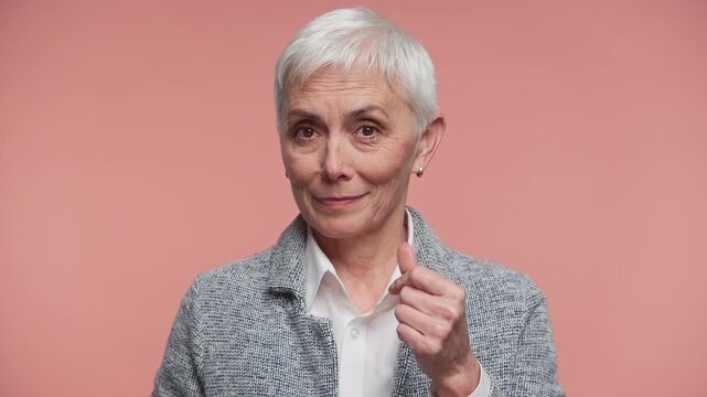 Senior woman making asking for money gesture