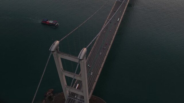 Aerial view of tsing ma bridge traffic with cargo ship