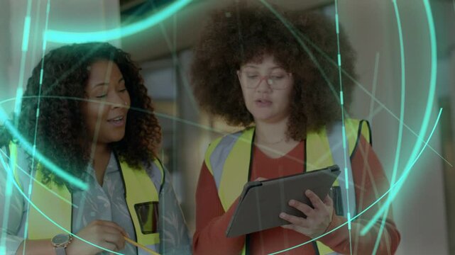 Site crew tapping tablet and pointing, causing teal AR rings wrapping around during plan review