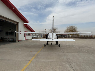 Small Airplane Parked Near Hangar © Azam Askarian