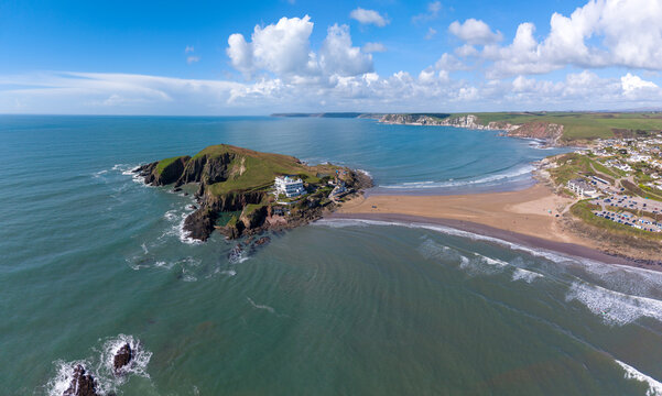 Aerial view of Burgh Island's tidal causeway, a sandy ribbon connecting the island to the mainland, amidst the turquoise sea, Burgh Island, England, United Kingdom.