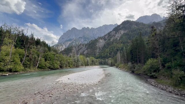 Running Enns river flowing through the limestone mountains of Gesause National Park, Austria