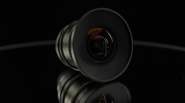 Professional cine lens on reflective black surface