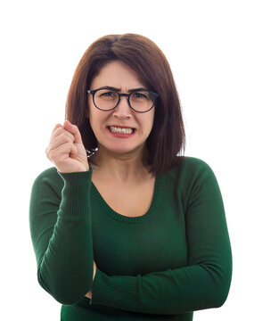 Angry and frustrated woman clenching teeth and holding fist tight, looks mad to camera. Annoyed teacher burnout, lady wearing eyeglasses scolding students. Anxiety feeling