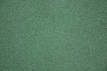 Green EPDM rubber crumb flooring texture. Seamless protective surface background pattern for outdoor kids playground or sports court. © Okta